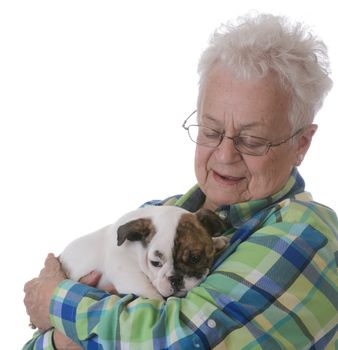 senior woman with bulldog puppy on white background