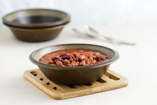 Hearty bowl of slow baked beans in a sauce.