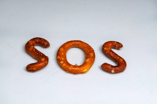 Savory biscuits as letters and the word SOS written.