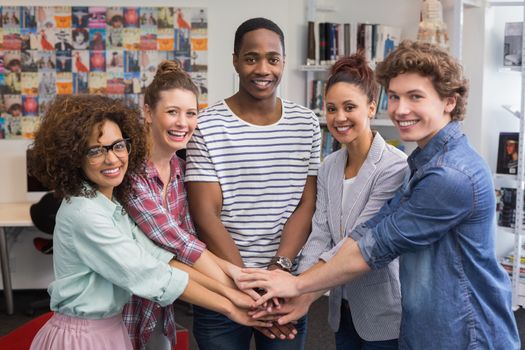 Fashion students smiling at camera together at the college