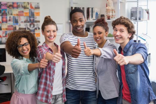 Fashion students smiling at camera together at the college