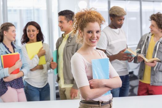 Fashion student smiling at camera at the college