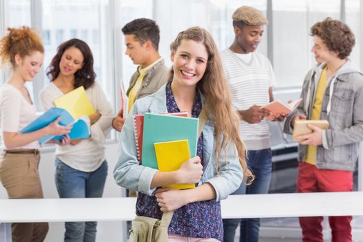 Fashion student smiling at camera at the college