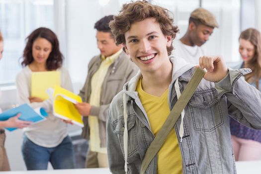 Fashion student smiling at camera at the college