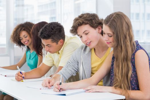 Fashion students taking notes in class at the college