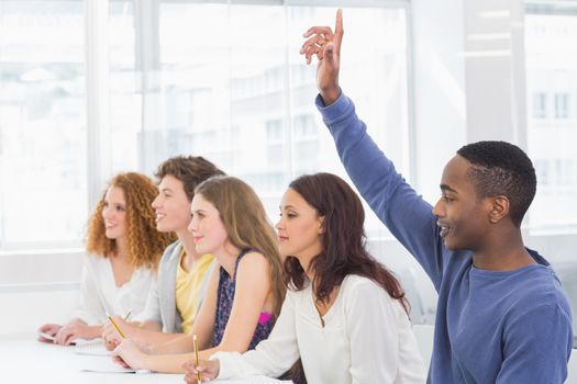 Fashion students being attentive in class at the college