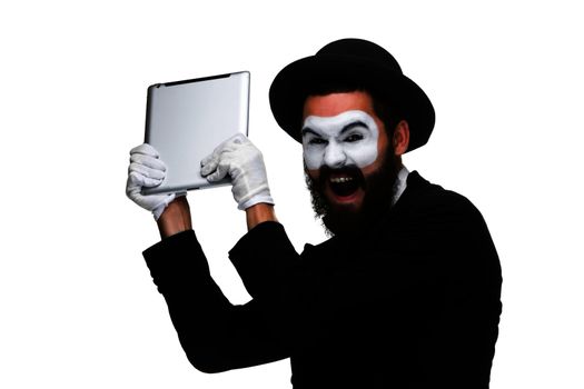 mime as a businessman throws computer in rage. Isolated on white background.  The concept of despair in business.