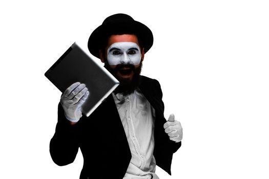 Man with a face mime working on a laptop isolated on a white background. concept of thinking in business