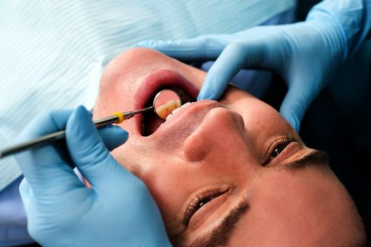 Male patient getting a dental checkup