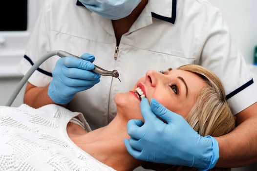 Female patient getting treatment from dentist
