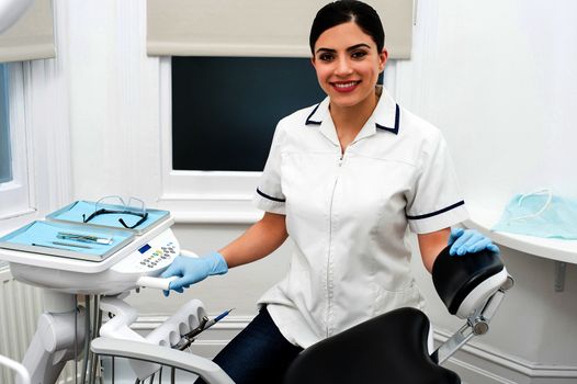 Female dental assistant with welcome smile