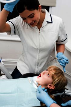 Little girl undergoing dental treatment at clinic