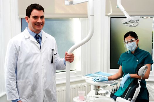 Male dentist and his female assistant posing