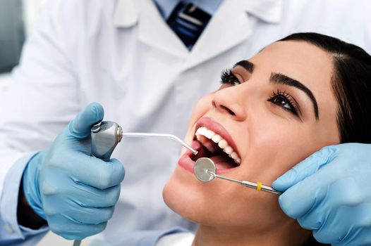 Young female patient whitening her teeth