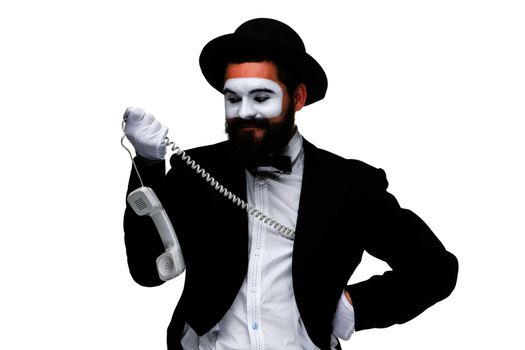 man in the image mime holding a handset isolated on white background. The concept -  I'm always in touch