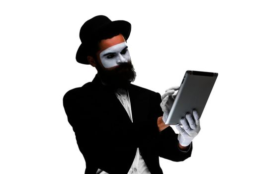 Man with a face mime working on a laptop isolated on a white background. concept of thinking in business