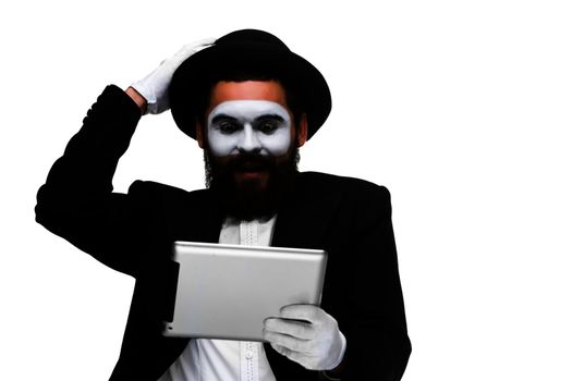 Man with a face mime working on a laptop isolated on a white background. concept of thinking in business