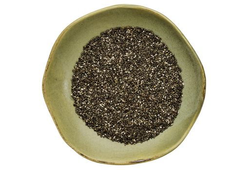 chia seeds (Salvia Hispanica) in a ceramic bowl isolated on white, top view