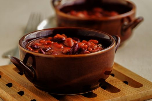 Bowls of mixed baked beans photographed closeup.