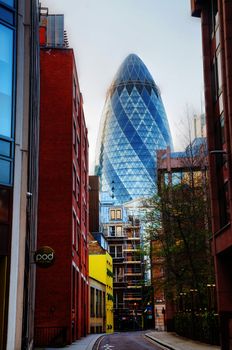 LONDON - APRIL 14: 30 St Mary Axe skyscraper on April 14, 2015 in London, UK. With 41 storeys, it is 180 metres tall and stands on the former site of the Baltic Exchange, which was extensively damaged in 1992.