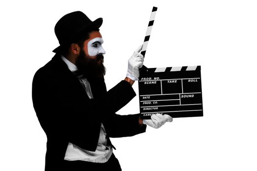 man in the image mime, dressed in black and white suit with movie board, isolated on a white background