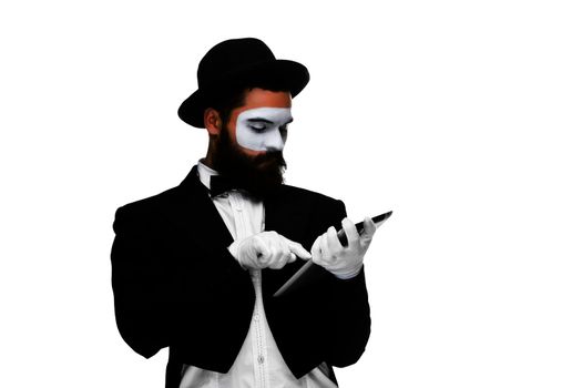 Man with a face mime working on a laptop isolated on a white background. concept of thinking in business