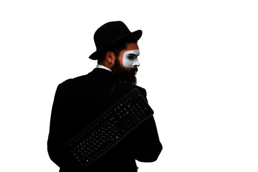 mime as a businessman holding a keyboard behind, isolated on white background. view from the back. concept of confident user