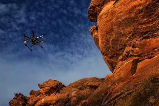 FORT COLLINS, CO, USA, February 12,  2015:  DJI F550 Flame Wheel  hexacopter drone is  flying with a camera along sandstone cliff.
