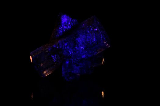 A macro photo of blue glowing crystals.