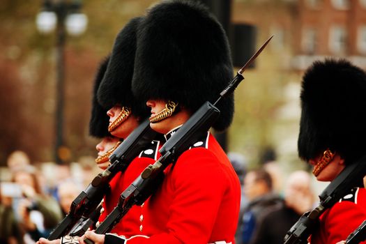 LONDON - APRIL 13: Queen's Guards at the Buckingham palace on April 13, 2015 in London, UK. It's the name given to the contingent of infantry guarding Buckingham Palace and St James's Palace.