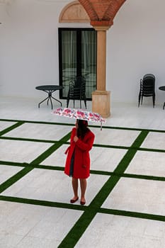 girl with a red coat on a white background