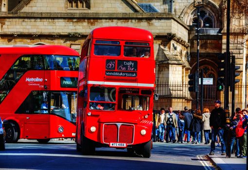 LONDON - APRIL 12: Iconic red double decker bus on April 12, 2015 in London, UK. The London Bus is one of London's principal icons, the archetypal red rear-entrance Routemaster being recognised worldwide.