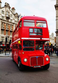 LONDON - APRIL 5: Iconic red double decker bus on April 5, 2015 in London, UK. The London Bus is one of London's principal icons, the archetypal red rear-entrance Routemaster being recognised worldwide.