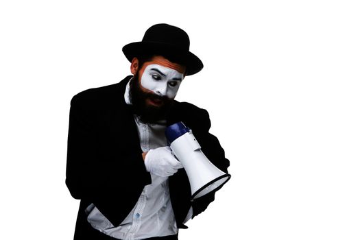 Man  with a face mime screaming into a megaphone, isolated on white background. concept of effective communication