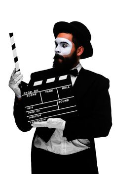 man in the image mime, dressed in black and white suit with movie board, isolated on a white background