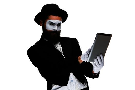 Man with a face mime working on a laptop isolated on a white background. concept of thinking in business