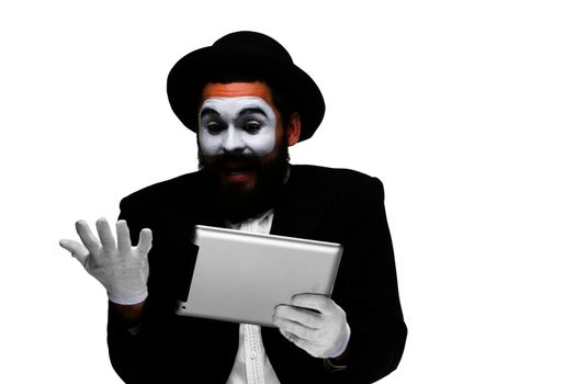 Man with a face mime working on a laptop isolated on a white background. concept of thinking in business