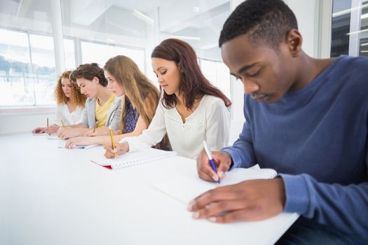 Fashion students taking notes in class at the college