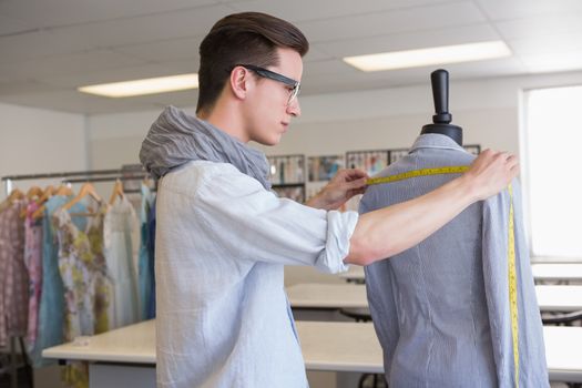 Fashion student working on mannequin at the college