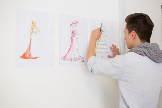 Fashion student drawing pictures on paper at the college