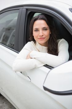 Young woman looking at camera in her car