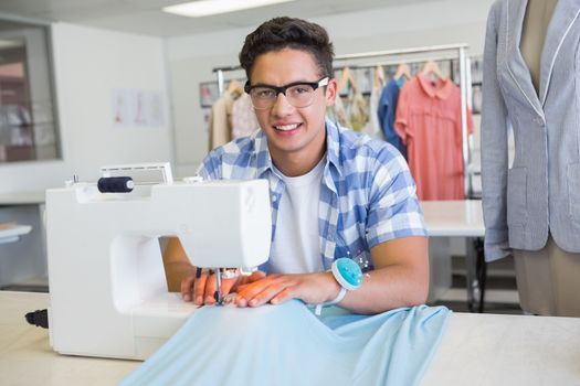 Fashion student using sewing machine at the college