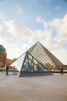 PARIS - OCTOBER 9: The Louvre Pyramid on October 9, 2014 in Paris, France. It serves as the main entrance to the Louvre Museum. Completed in 1989 it has become a landmark of Paris.