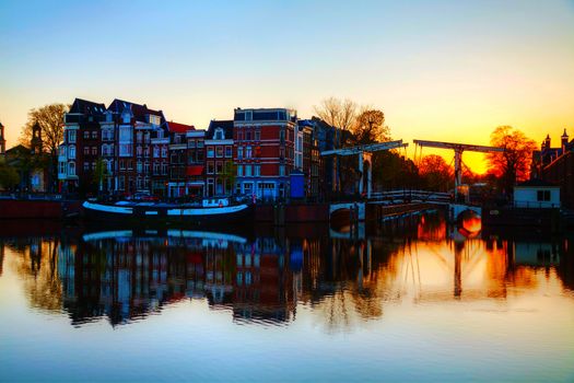 City view of Amsterdam, the Netherlands at sunrise with Amstel river