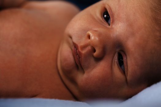 Close up Cute White New Born Baby Lying in Prone on White Cotton Cloth with Open Mouth