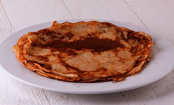 Delicious Pancakes on Plate Served, Isolated on White Wooden Table