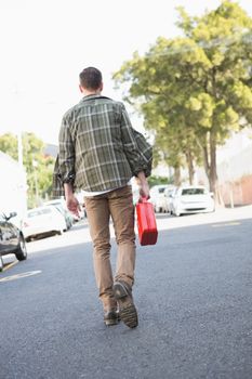 Man bringing petrol canister to a broken down car in the street