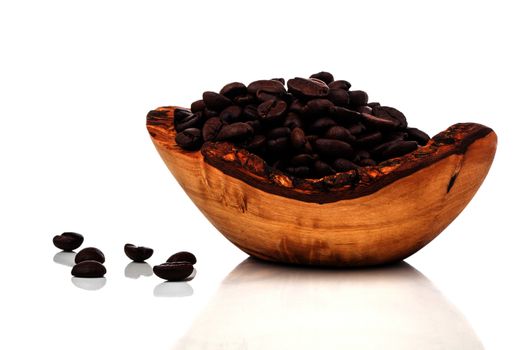 coffee beans in a wooden bowl, on white background