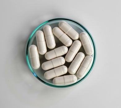 Close up of white medical capsules on white background