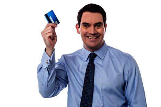 Smiling male executive showing his cash card